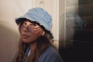 Our take on the vintage bucket hat. Our Denim bucket hat has distressed edges and our signature embroidered logo for a vintage streetwear vibe. Unisex, one size fits all. 